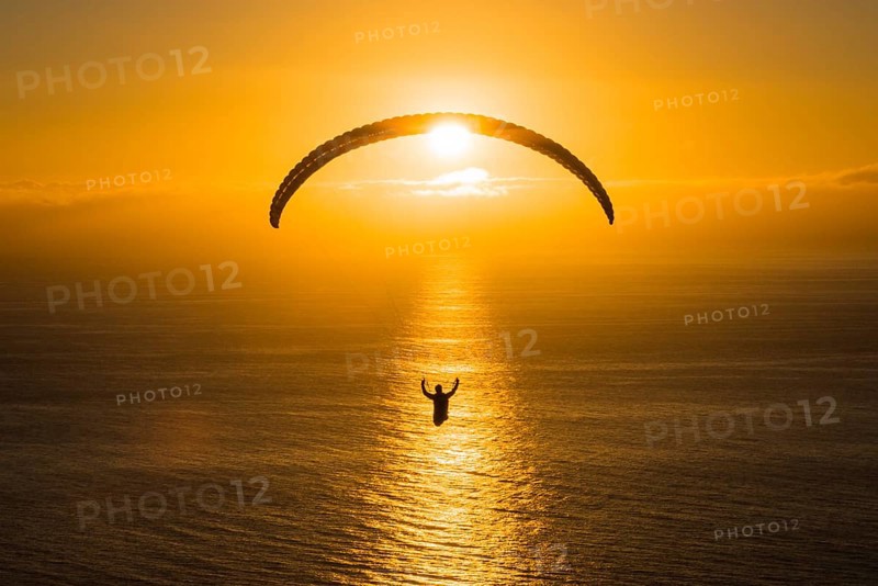 Paraglider over the Atlantic near Puerto Naos during sunset