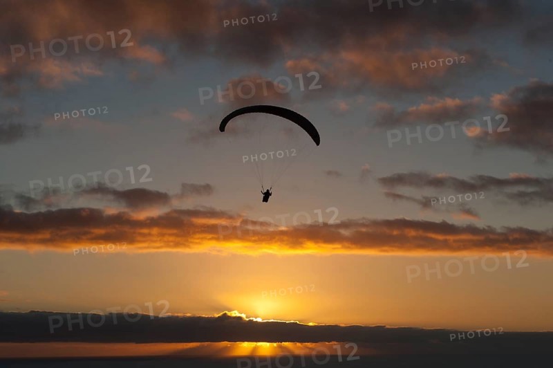 Paragliding over the Atlantic near Puerto Naos during sunset