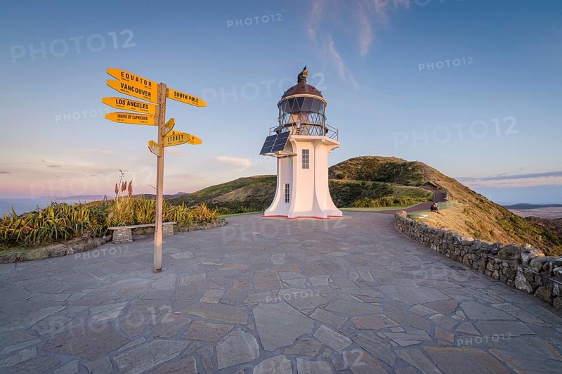 International signpost at the lighthouse at Cape Reinga in evening mood