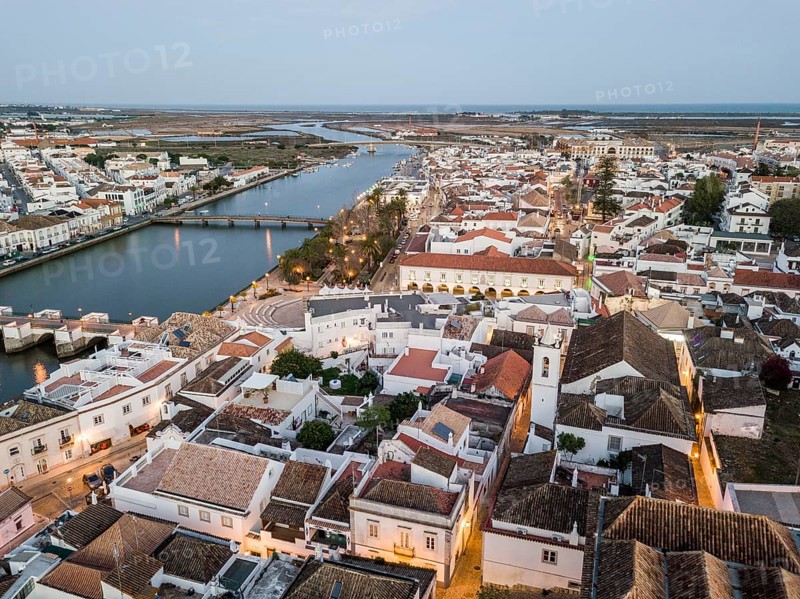 City view with roman bridge over Gilao river in old fishermen's town in the evening light