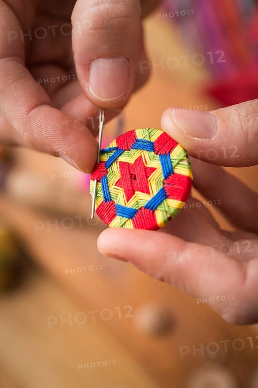 Button maker stitching and wrapping green