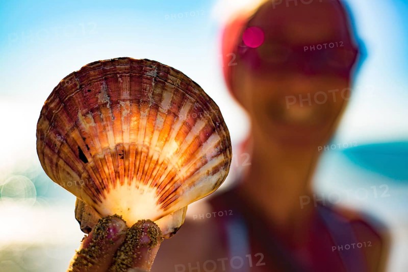 Woman holding a fan shell