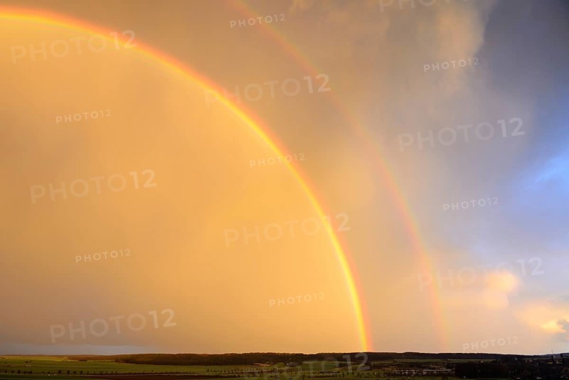 Double rainbow over agricultural landscape
