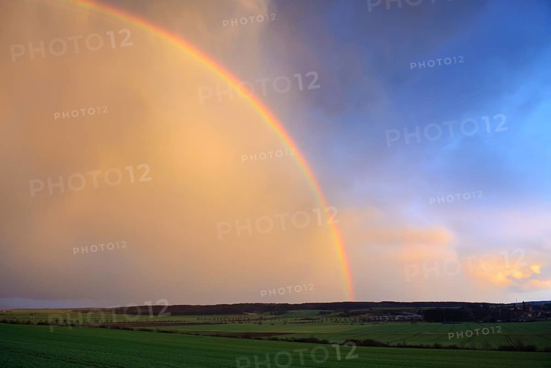 Double rainbow over agricultural landscape