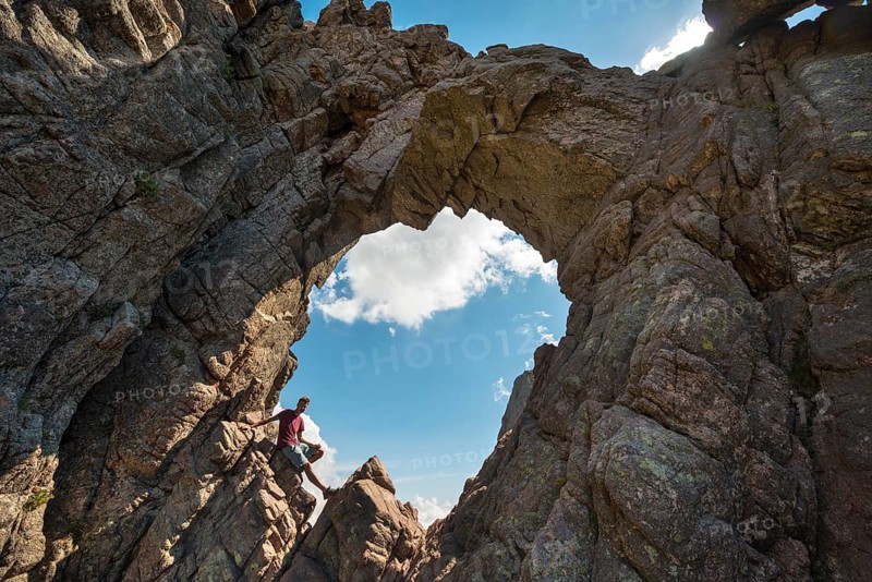 Young man sitting in bomb craters