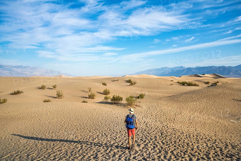 Young man hiking on sand dunes