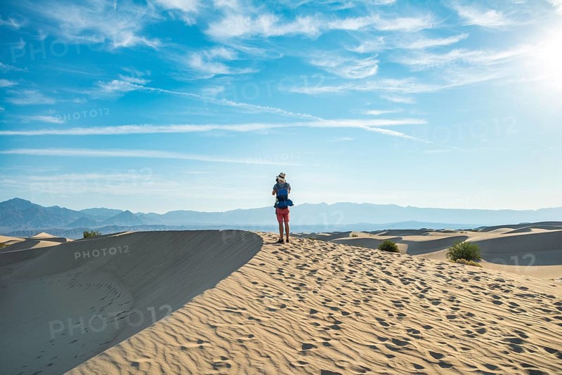 Young man photographing sand dunes