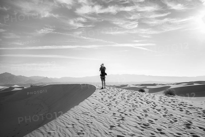 Young man photographing sand dunes