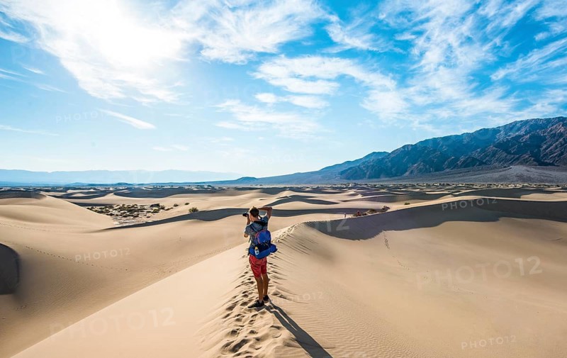 Young man photographing sand dunes