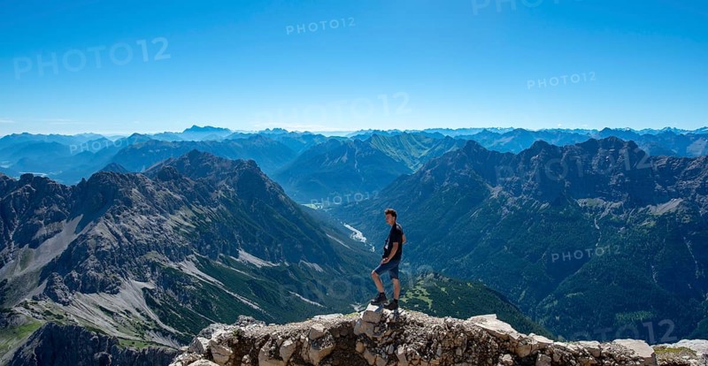 Hiker at the summit of the Hochvogel
