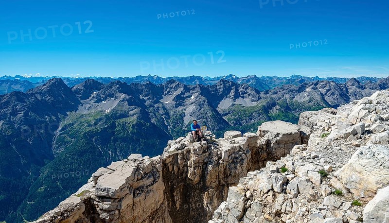 Hiker sits on rocks