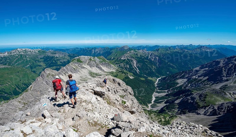 Two hikers descending from the summit of the Hochvogel