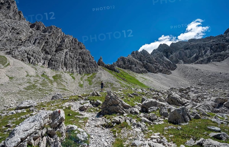 Hiker on hiking trail from Hochvogel to Prinz Luitpold Haus