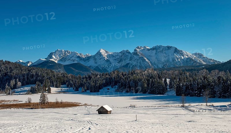 Frozen Lake Geroldsee in winter in front of Karwendel Mountains