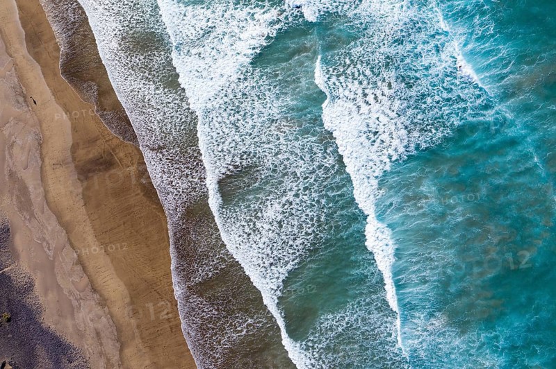 Waves running out at sandy beach