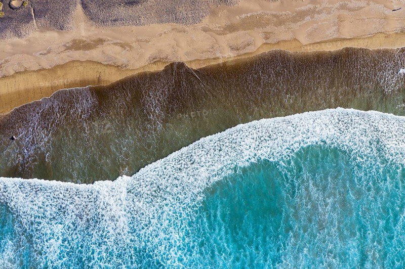 Waves running out at sandy beach