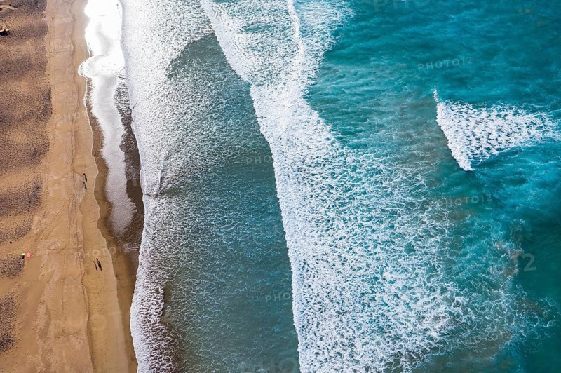 Waves running out at sandy beach