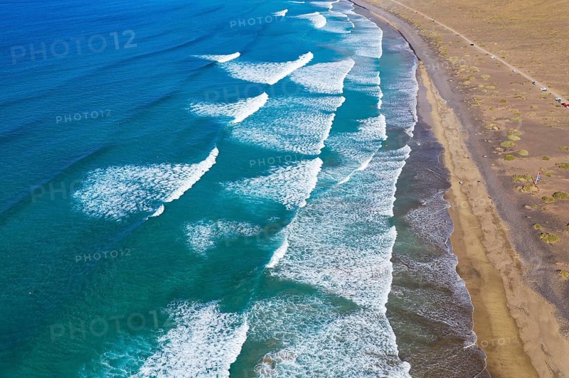 Waves running out at sandy beach