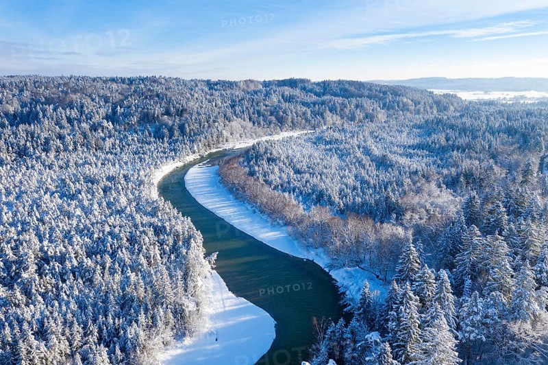 Isar meanders through snow-covered forest area