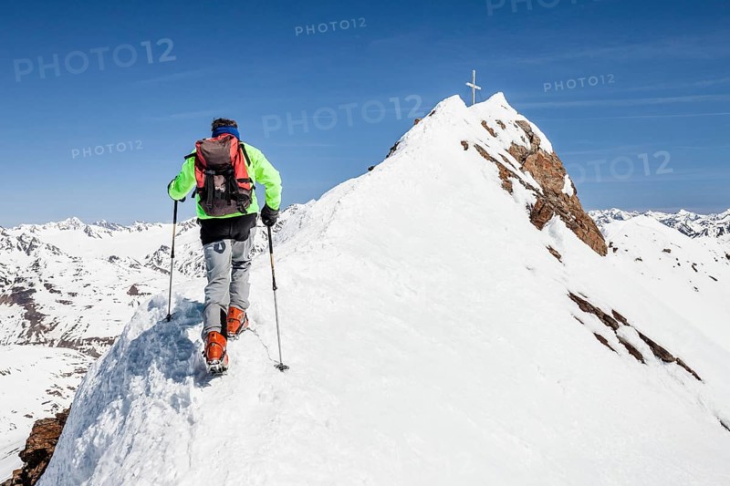 Ski tourer on ridge ascending Finailspitze in Schnals at Schnalstal Glacier