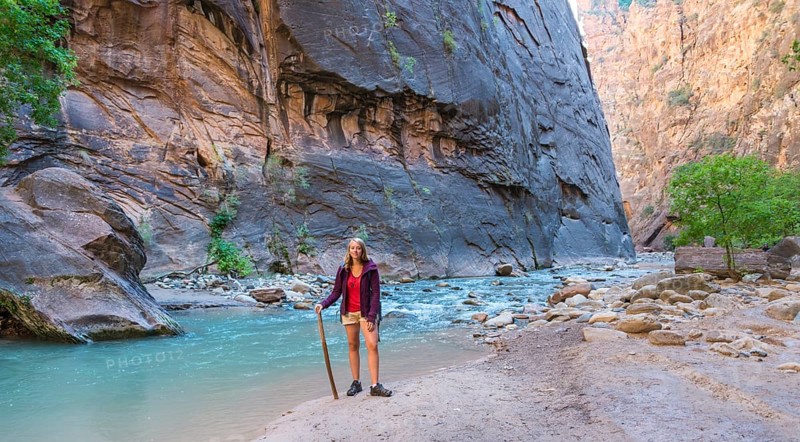 Hiker standing next to river