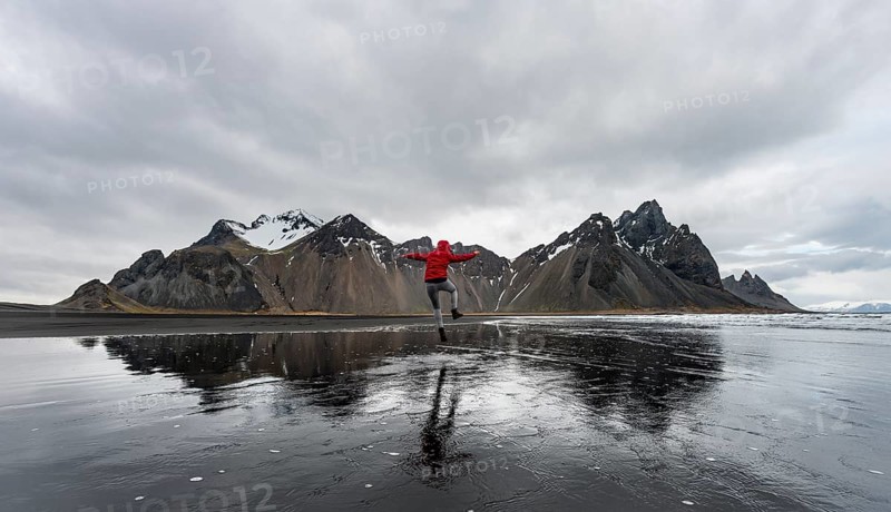 Hiker jumping at beach