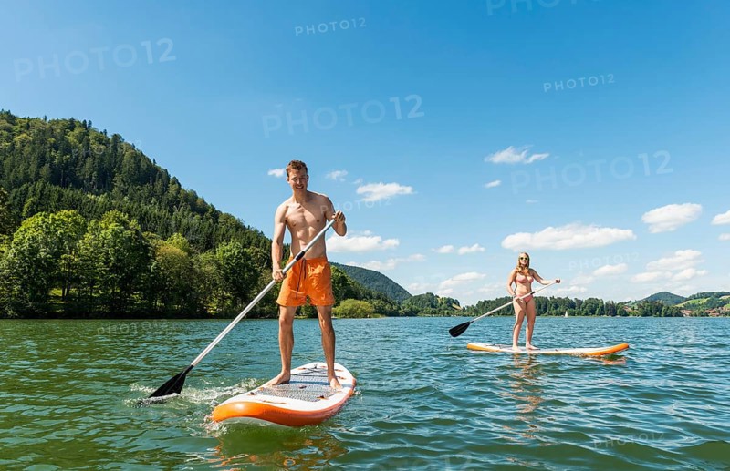 Young man and woman on paddle boards
