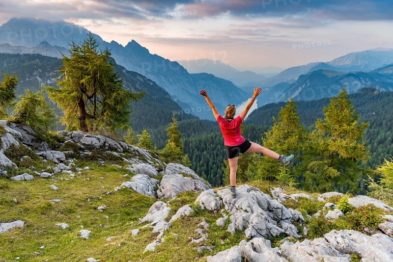 Hiker stretches arms into the air