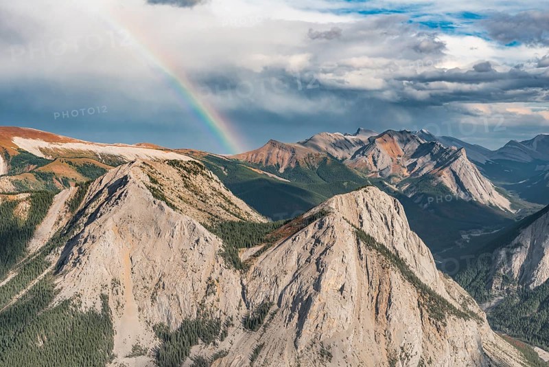 Panoramic view on mountain landscape with rainbow