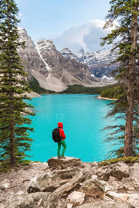 Hiker standing on the shore of a lake