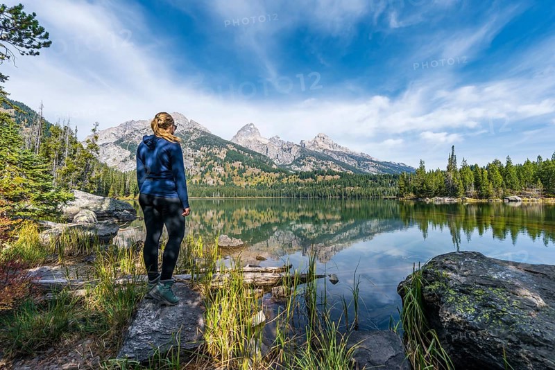 Young woman standing at a lake
