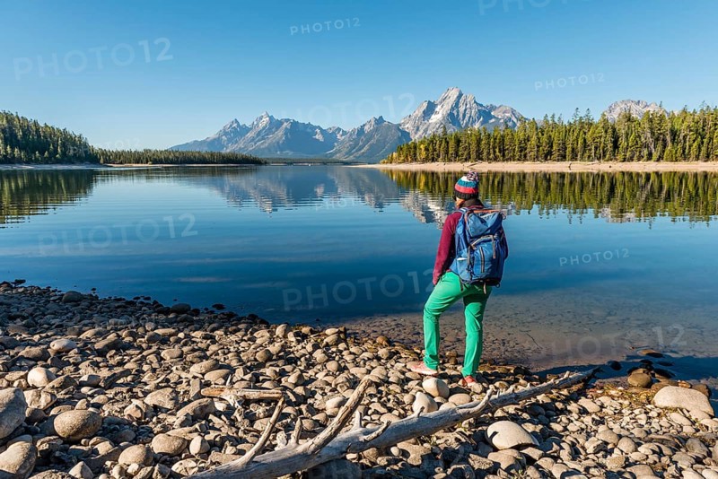 Young woman with rucksack standing on shore