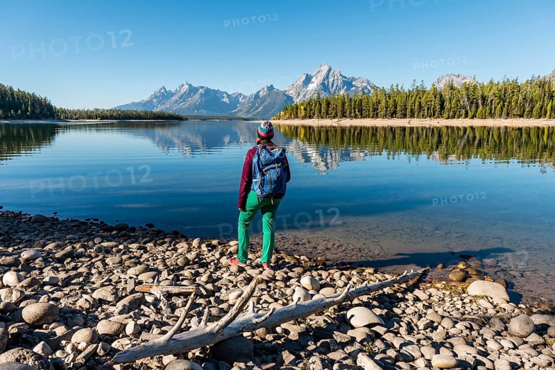 Young woman with rucksack standing on shore