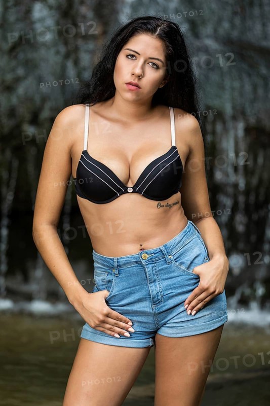 Young woman poses in bra and hotpants