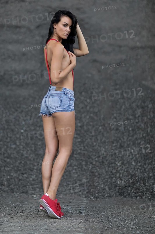Woman with jeans hotpants and red suspenders