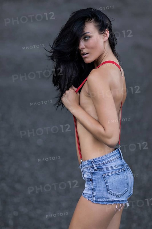Woman with jeans hotpants and red suspenders