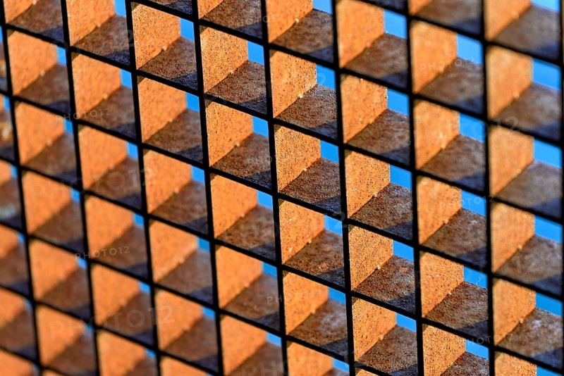 Rusty grid against a blue sky