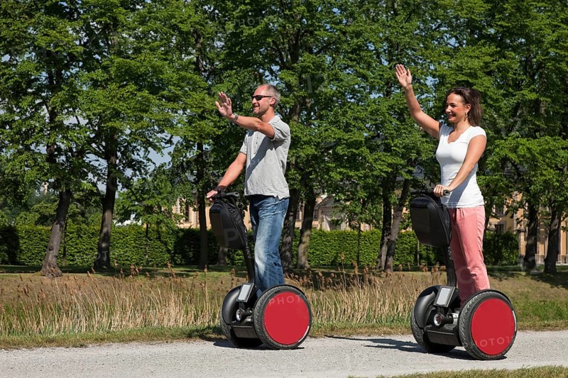 Man and woman riding Segways and having fun