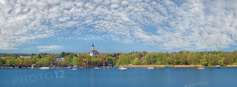 Lake Ammer shore with the Marienmunster and white-blue cloudy sky