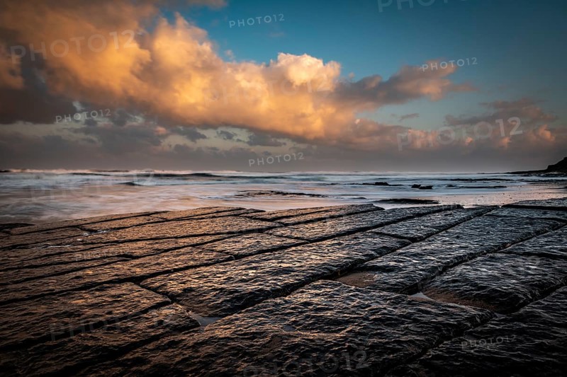 Coast with granite rocks washed by the sea in the evening light