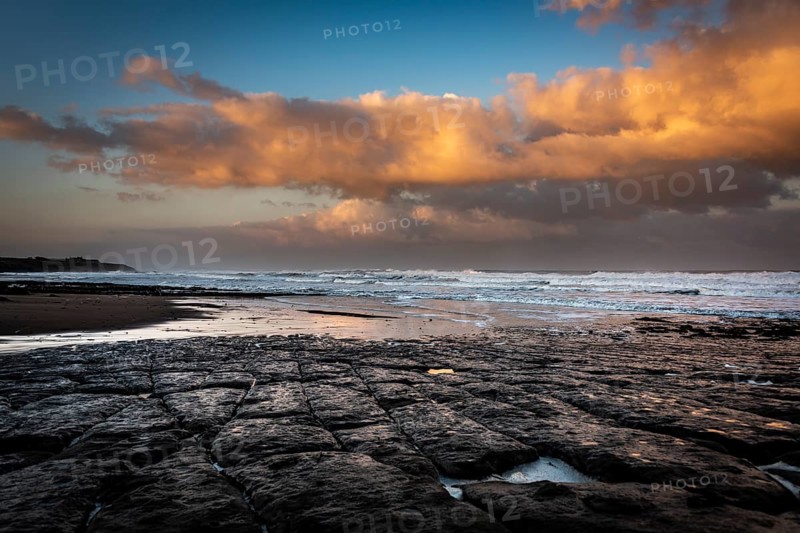 Coast with granite rocks washed by the sea in the evening light