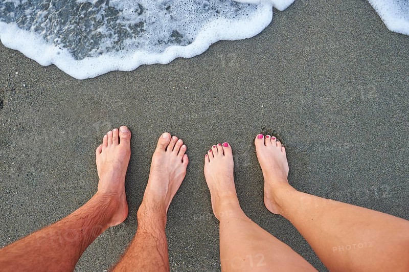 Two feet standing at the surf from the sea
