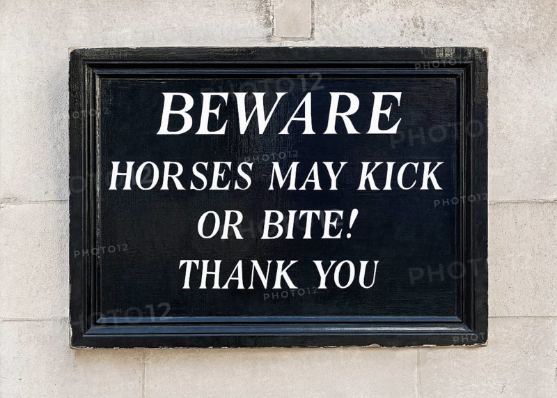 Beware horses may kick or bite sign