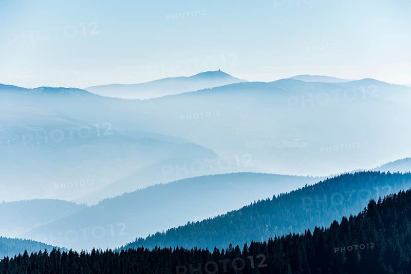 Staggered mountain ranges in the haze