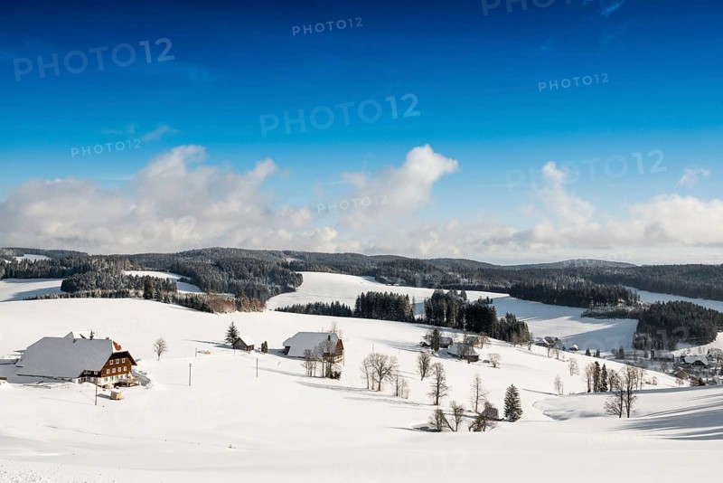 Snow-covered landscape and farmhouses