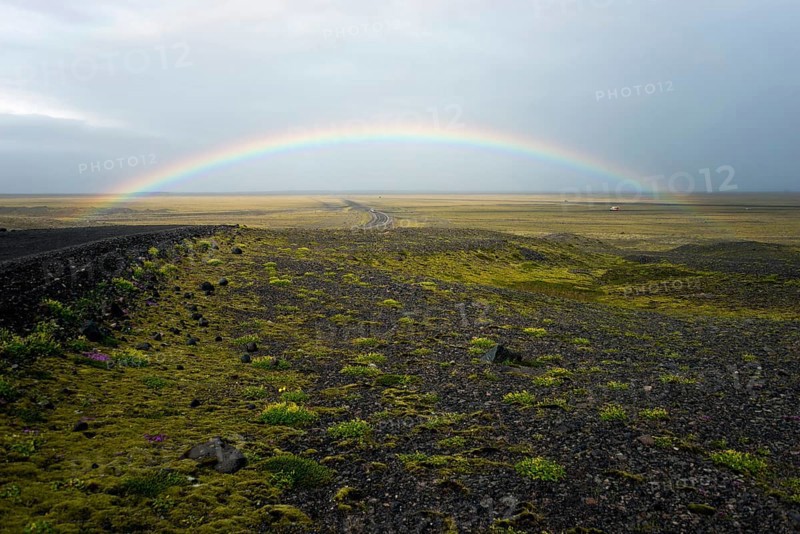 Rainbow over flat volcanic landscape near Braidarmerkursandur