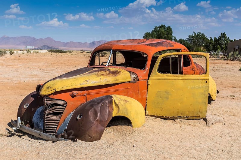 Old car wreck in sand