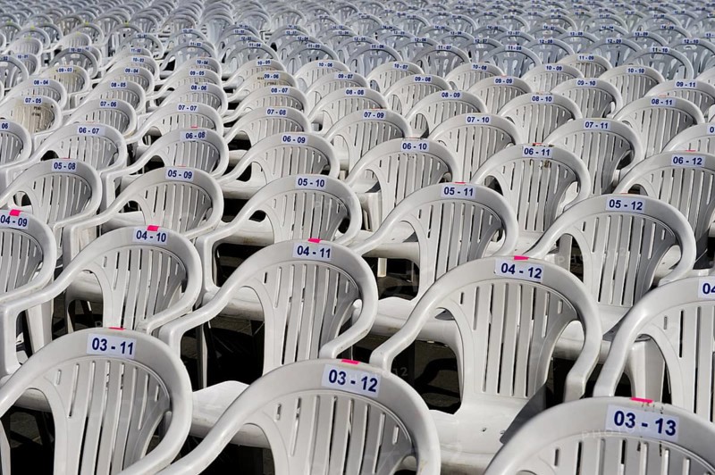 Numbered white plastic chairs