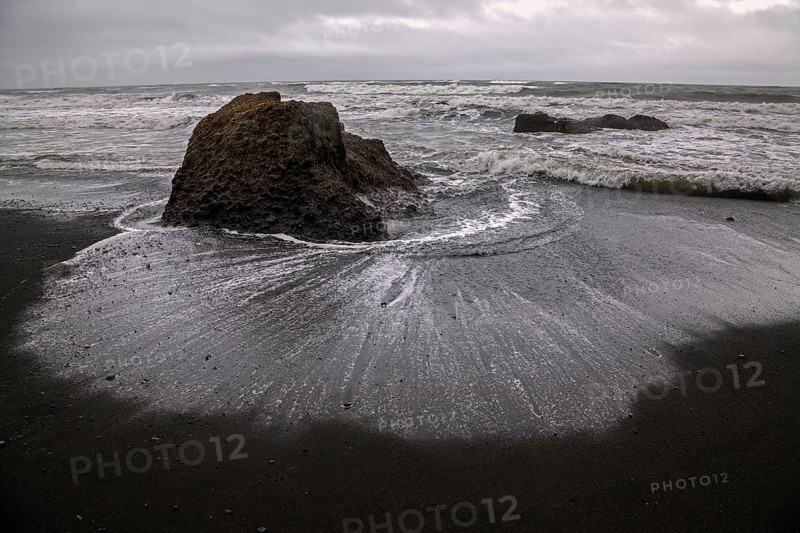 Lava beach and disturbed sea