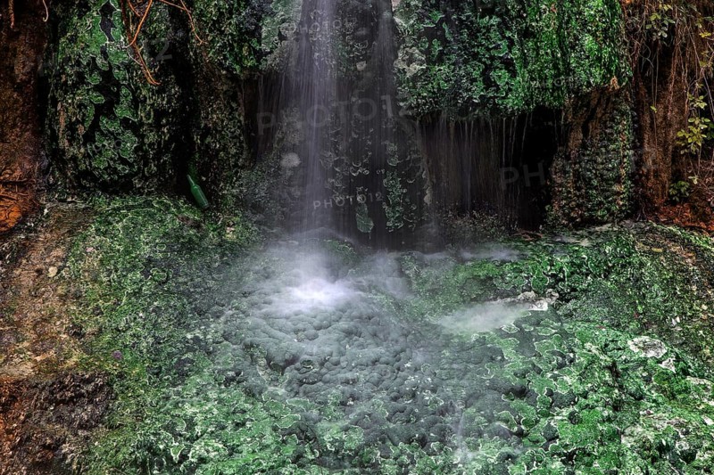 Small waterfall with green mineral deposits